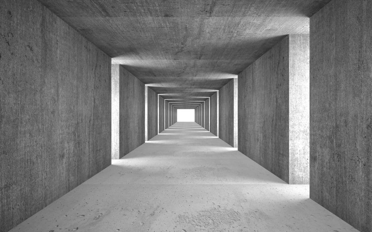 A concrete corridor receding in square frames